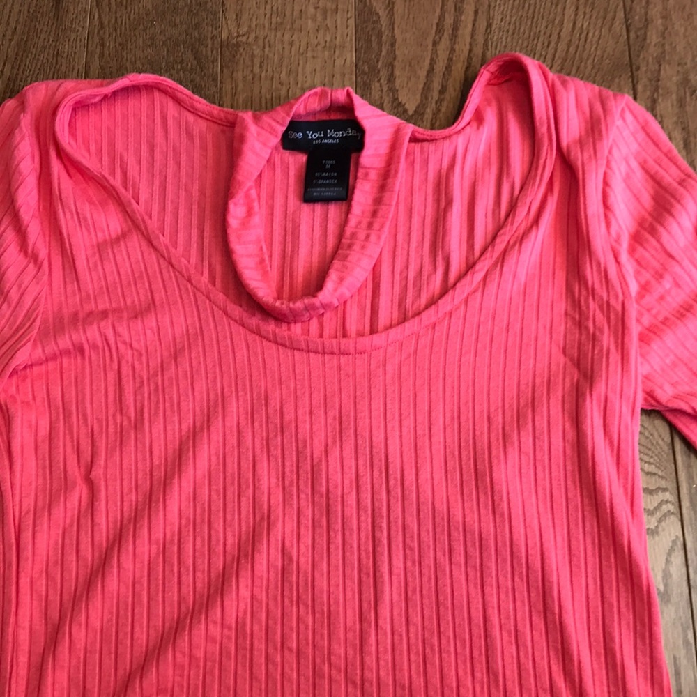 Bright pink crop top.